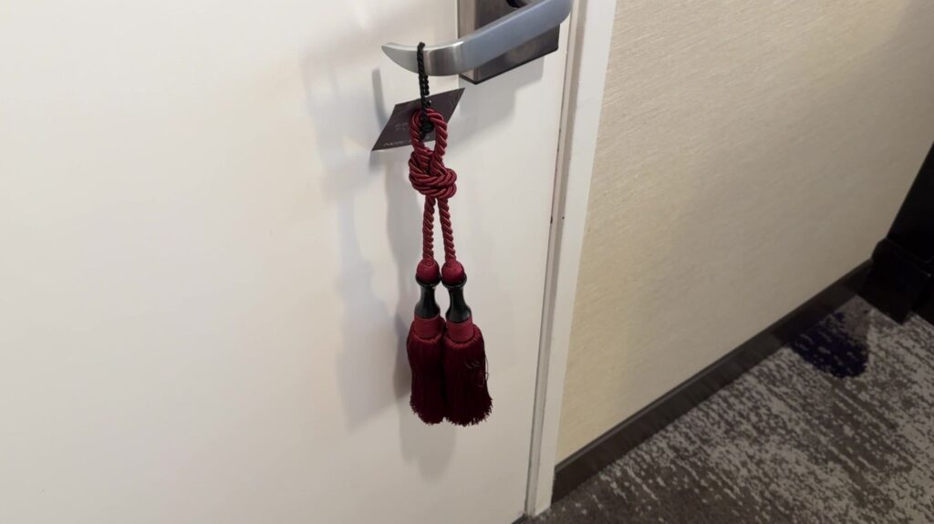 A tassle hanging from the door handle.