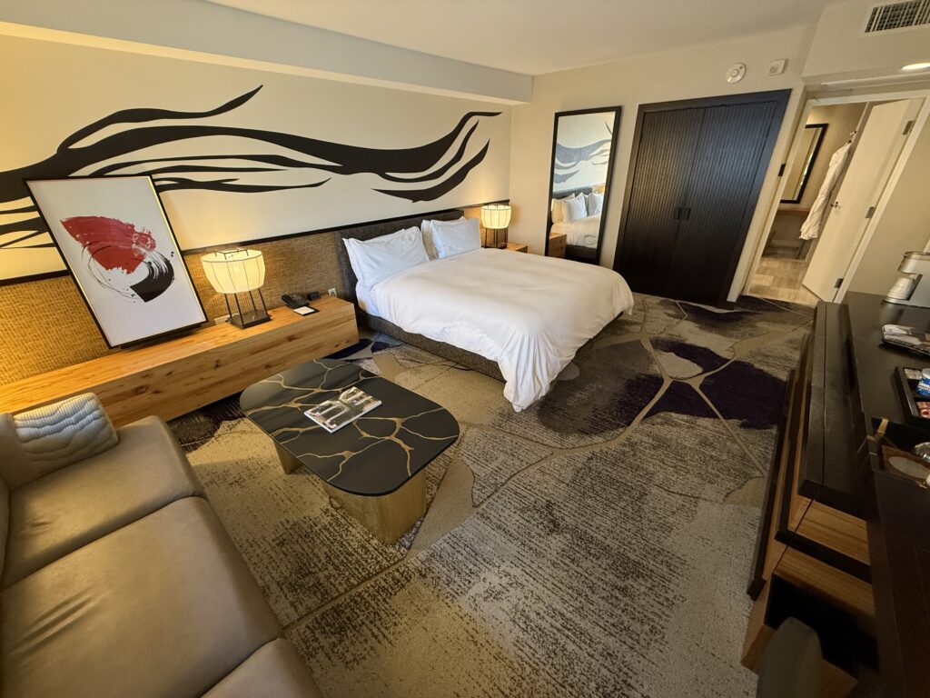 Another angle of the room that shows the king bed with the doorway to the bathroom behind it.