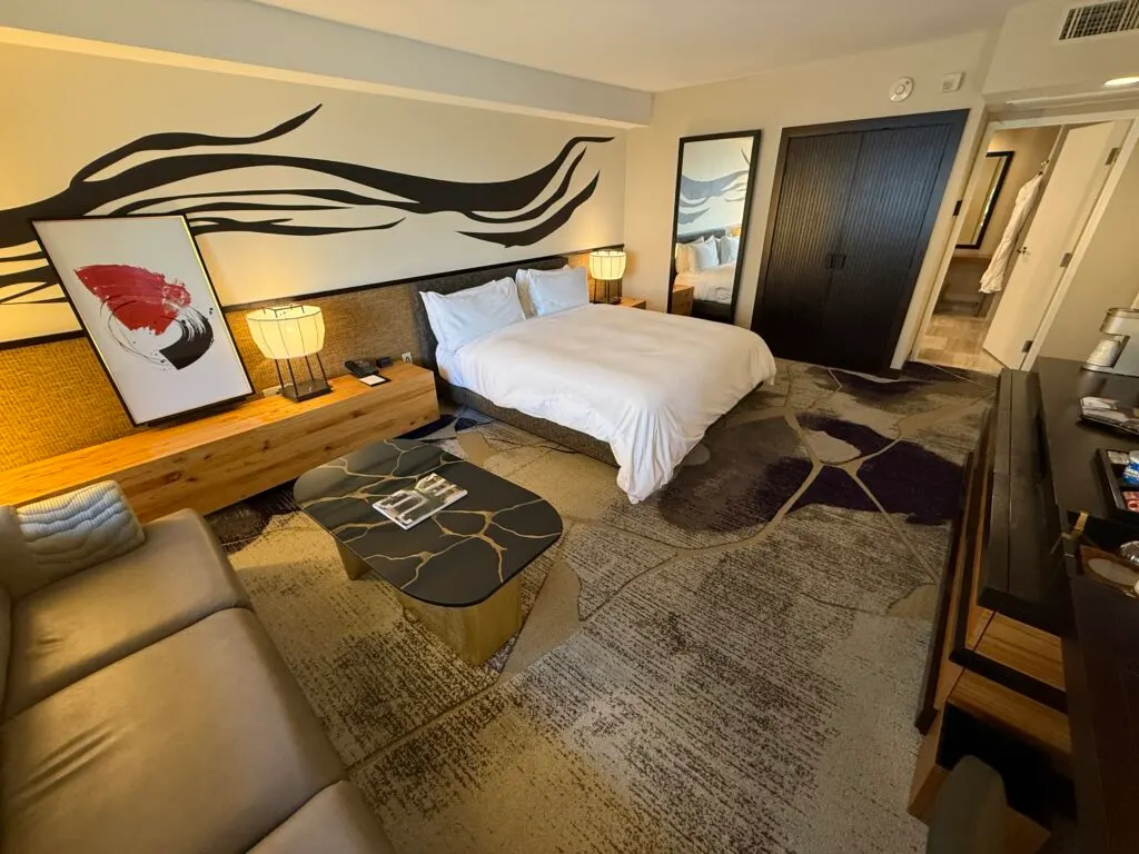 Another angle of the room that shows the king bed with the doorway to the bathroom behind it.