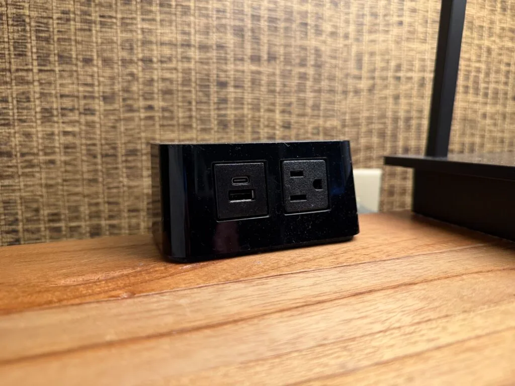 A bank of bedside charging options that include an outlet, USB A, and USB C ports.