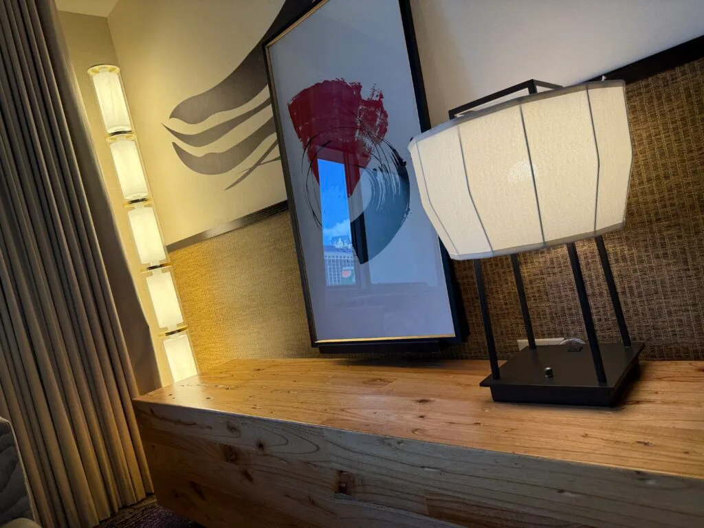 2 lamps on either side of a portrait of a flower.