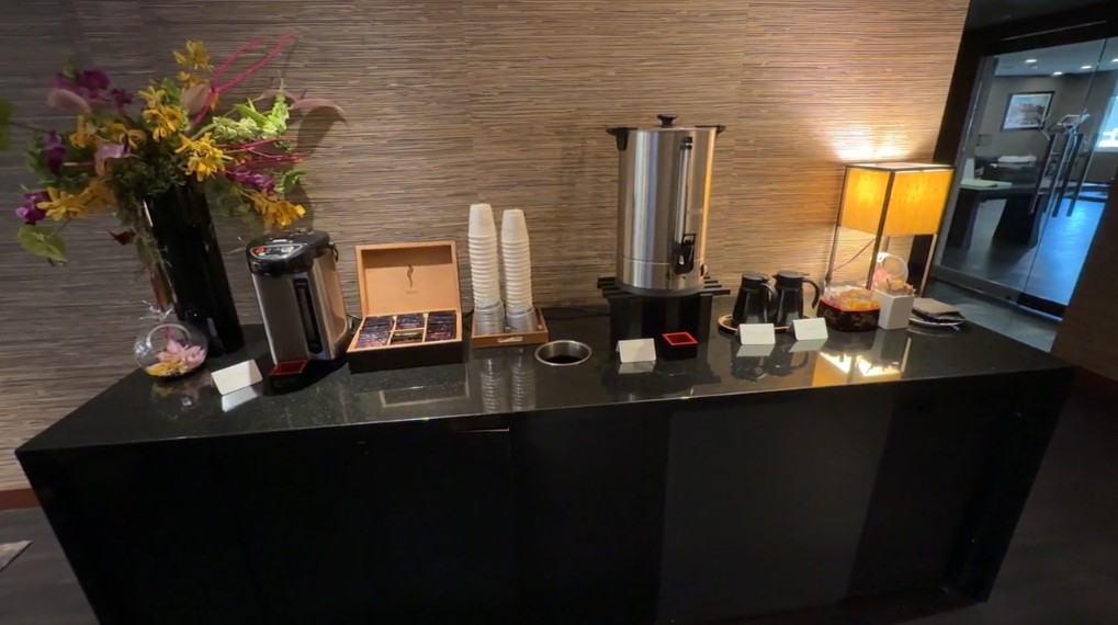 A table in the hotel lobby stocked with coffee and tea.