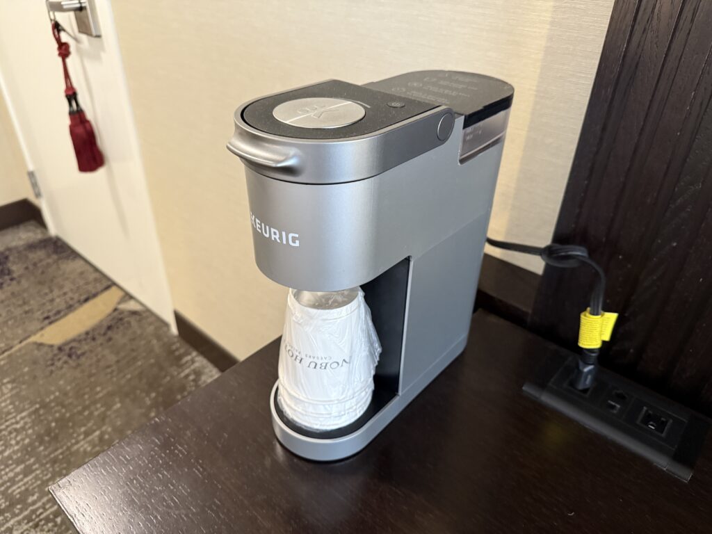 A coffee machine with empty cups at the ready, but no coffee.