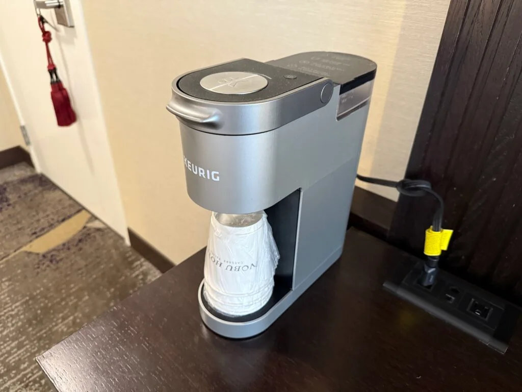 A coffee machine with empty cups at the ready, but no coffee.