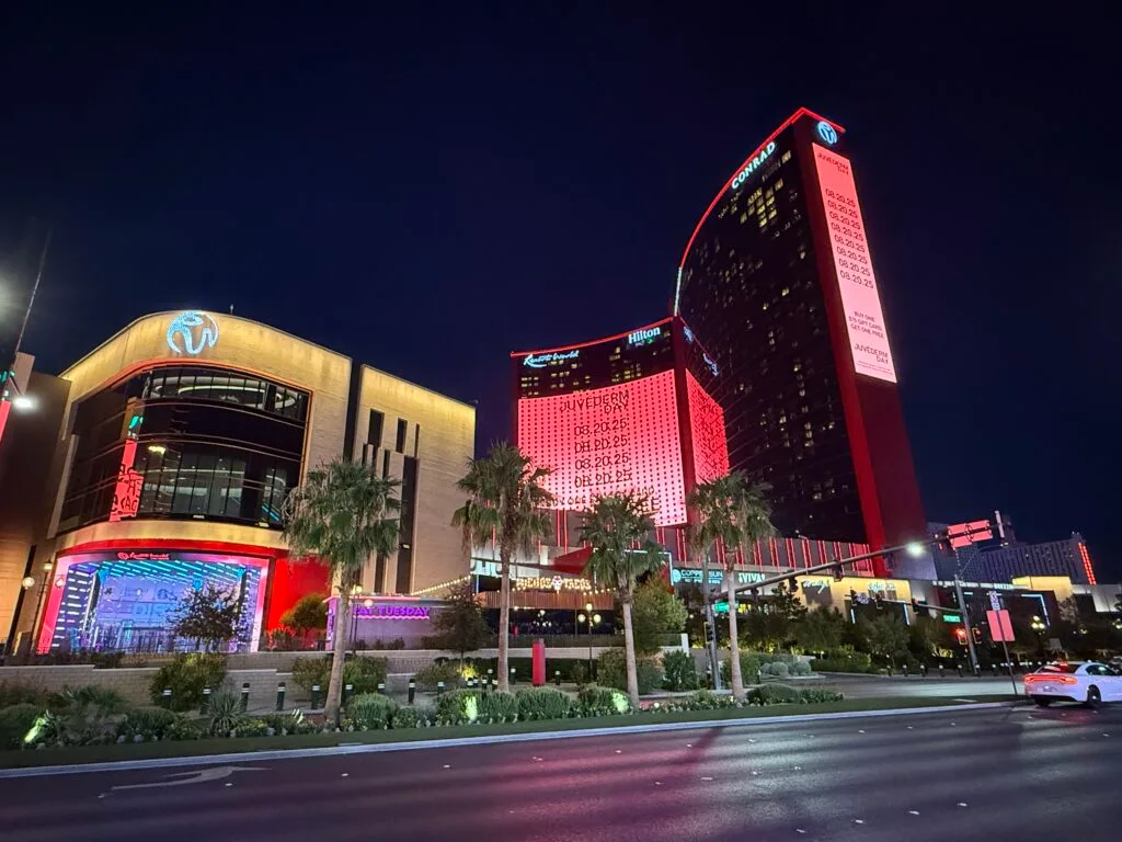 Exterior of Resorts World at night from across the street.