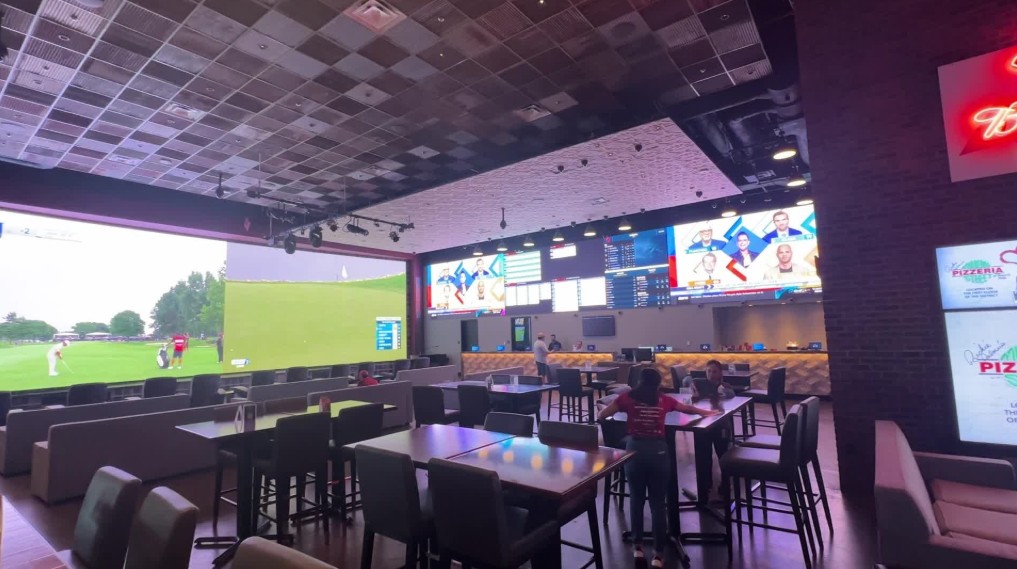 Large LED screens on the walls of the sportsbook.