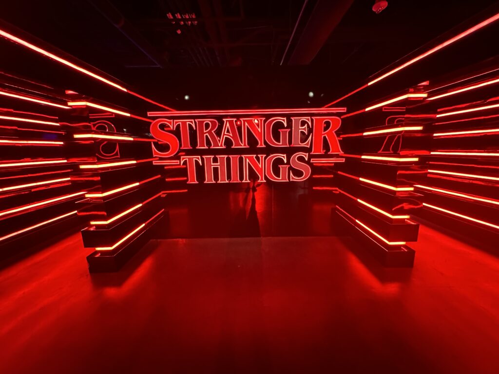 An illuminated Stranger Things logo.