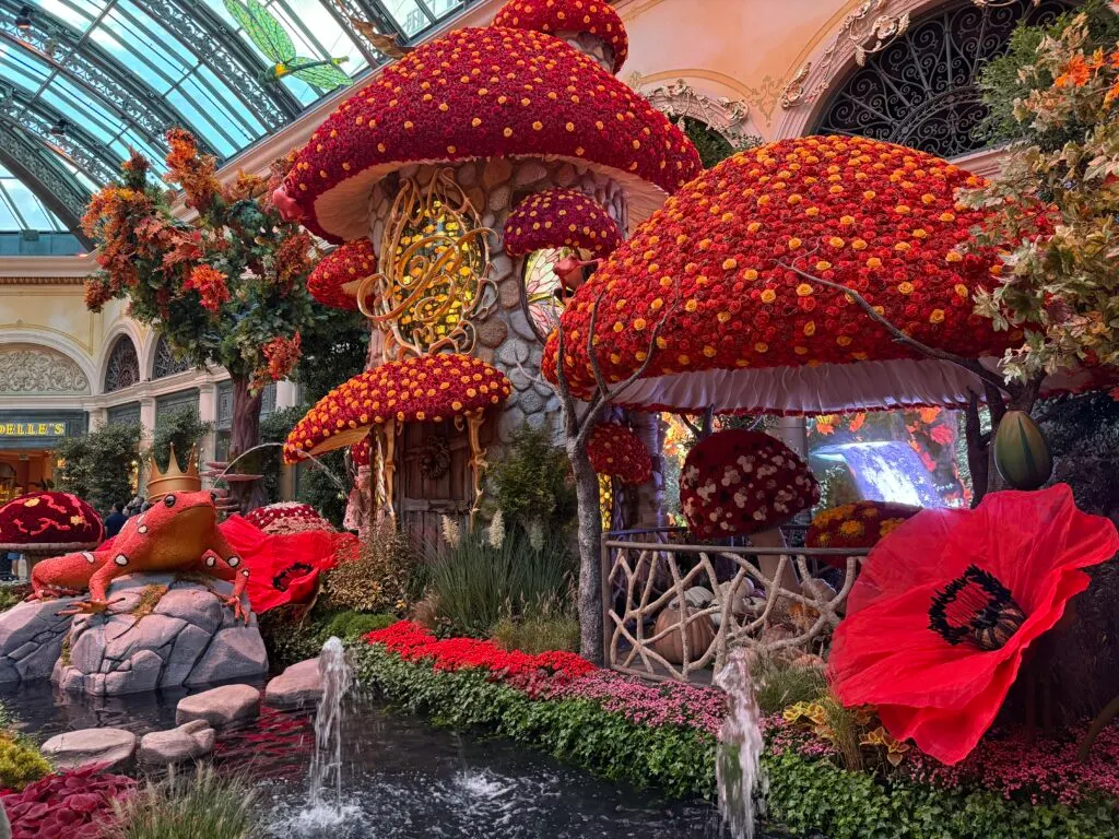 Mushroom style homes with roofs made of red flowers. 