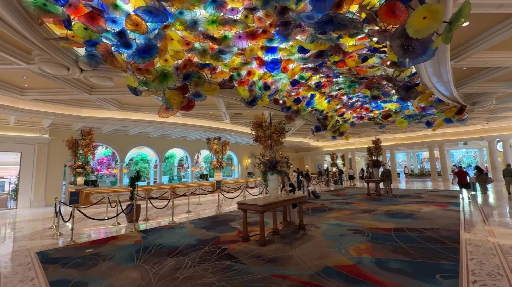 Bellagio's hotel lobby, with backlit colorful glass flowers spreading across the cieling. 