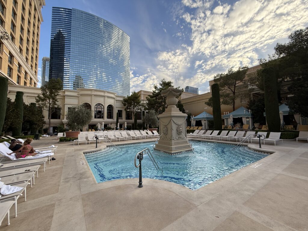 A small pool with a fountain feature in the middle of it.