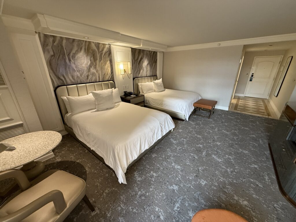 Another angle of the beds that shows the hallway into the room in the background.