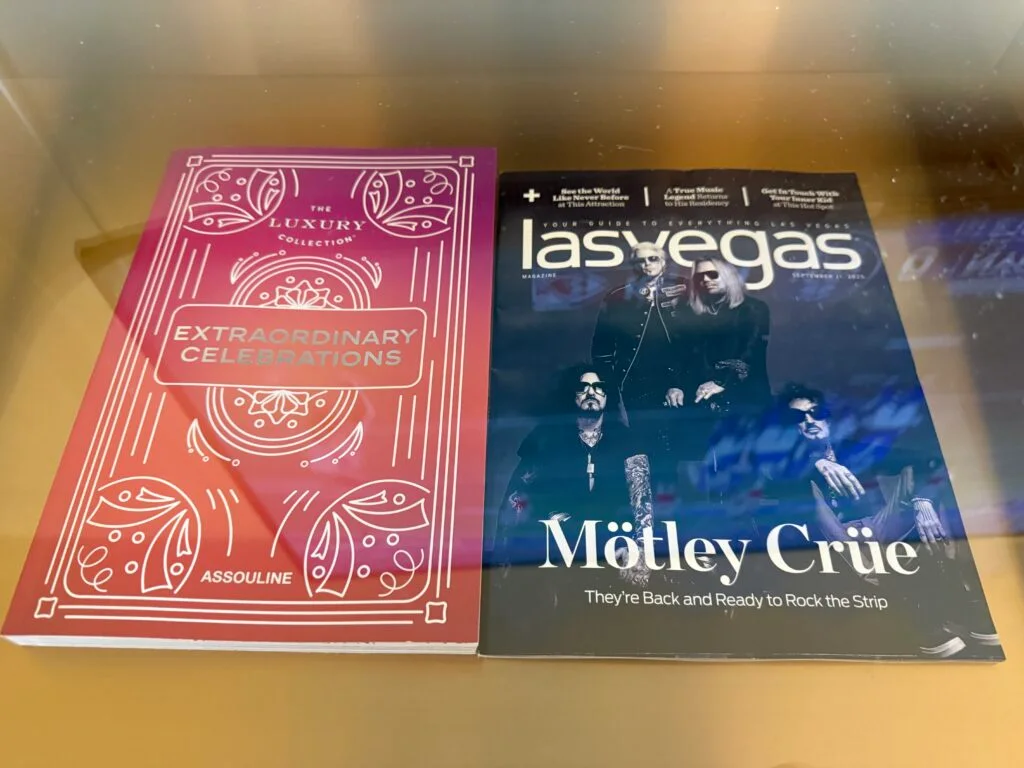 2 magazines on a shelf. 