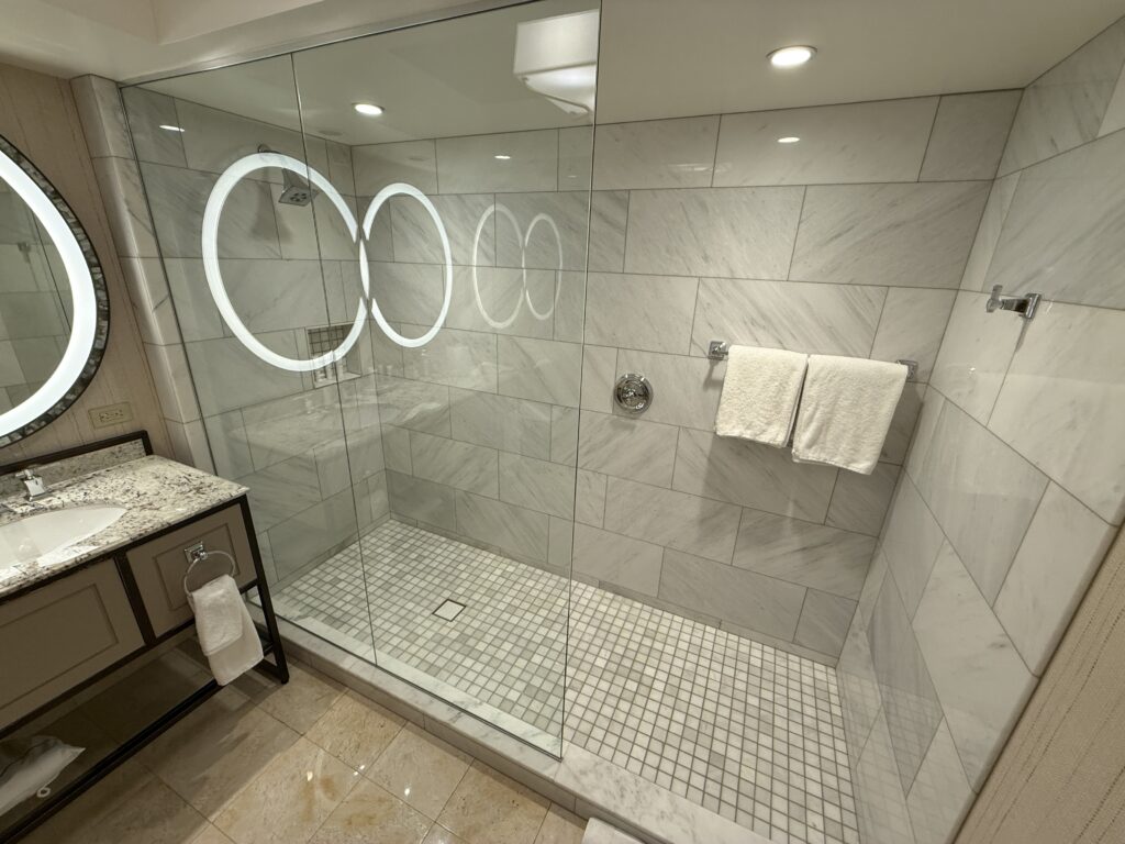 A LONG shower, with a half glass partition.