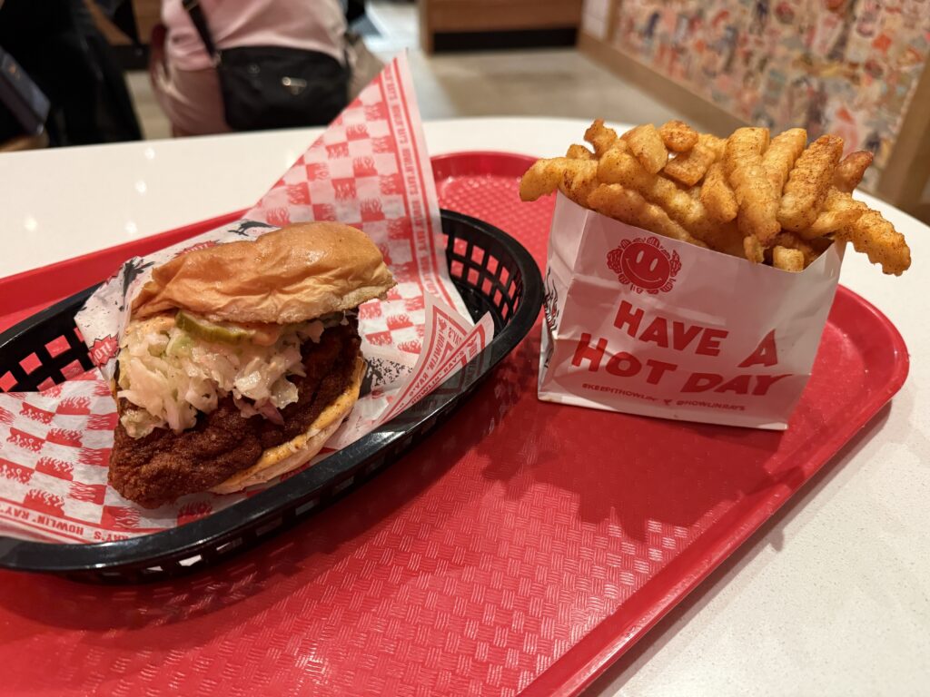 My sandwich sitting next to a little pouch of crinkle cut french fries.