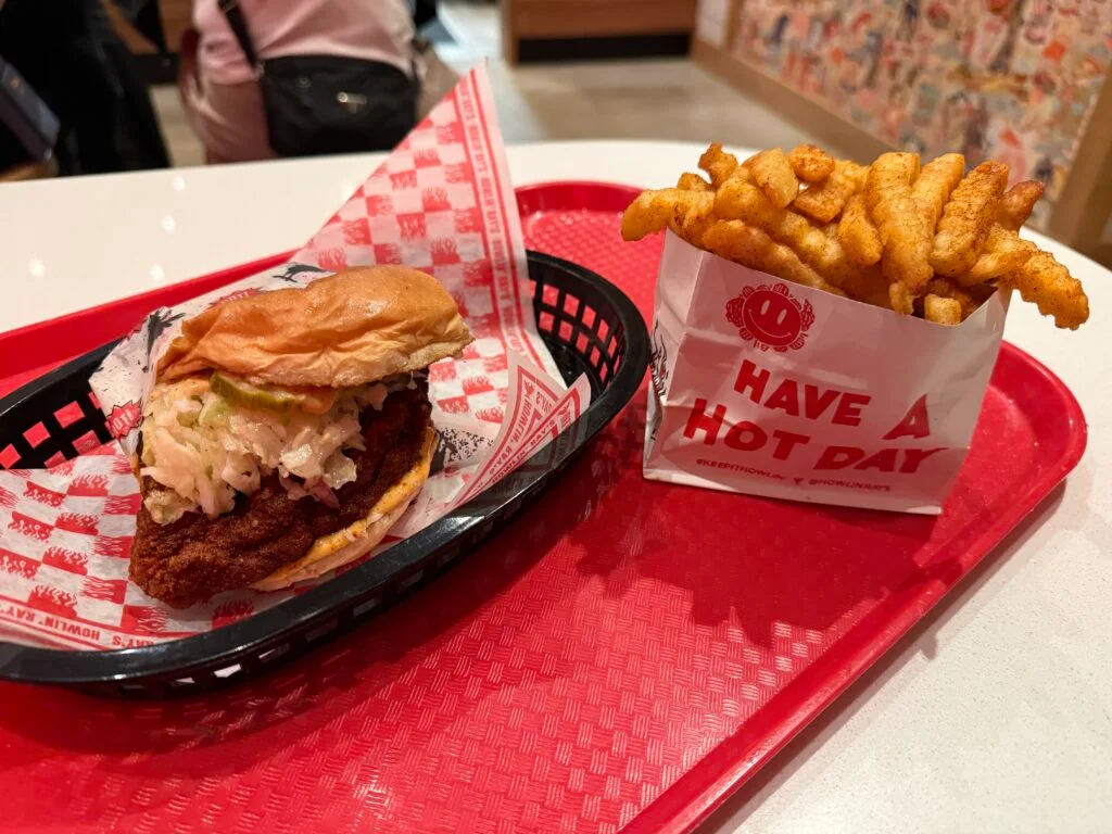 My sandwich sitting next to a little pouch of crinkle cut french fries. 