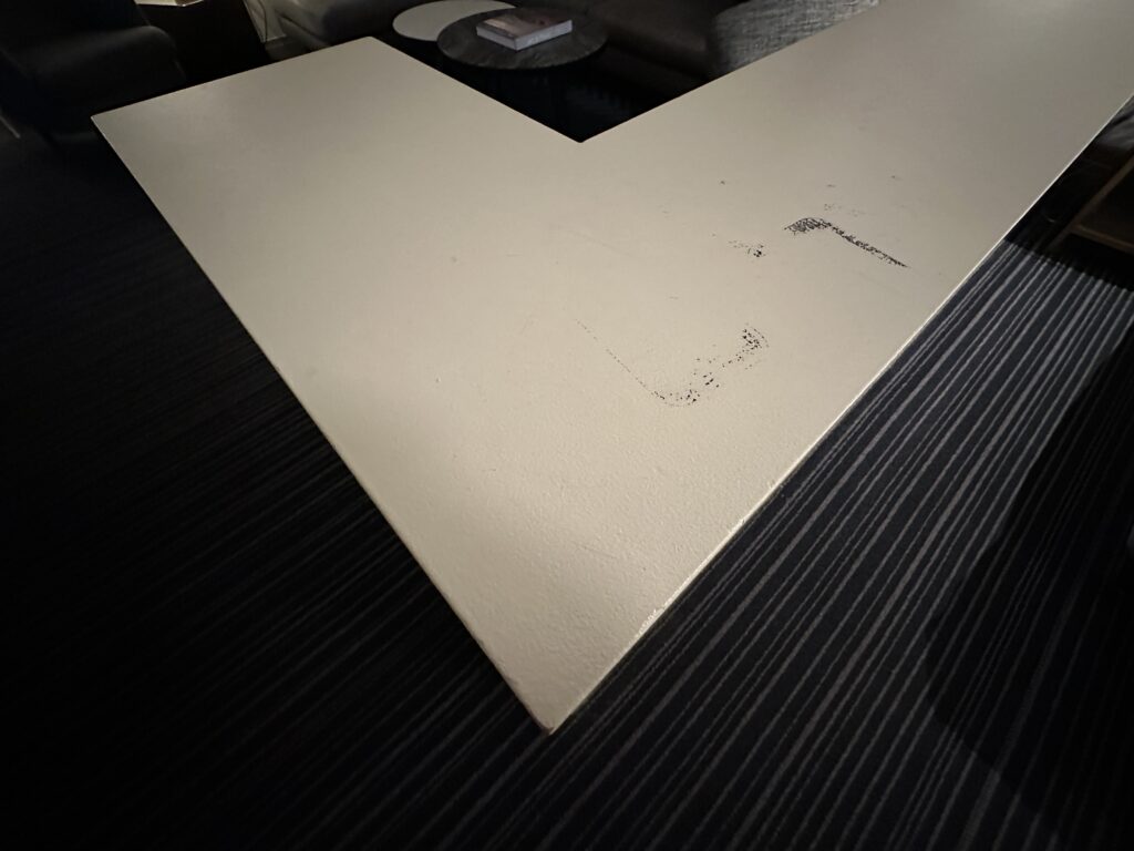 A black scuff atop the white dividing wall.
