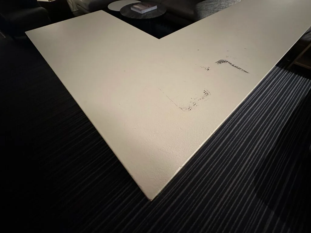 A black scuff atop the white dividing wall. 