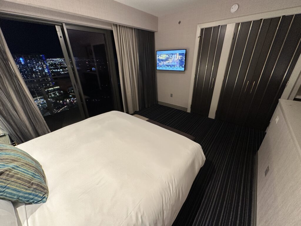 The bed, pointed at a TV mounted on the wall.