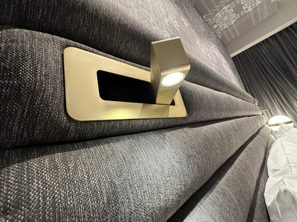 A pop out reading light in the headboard.