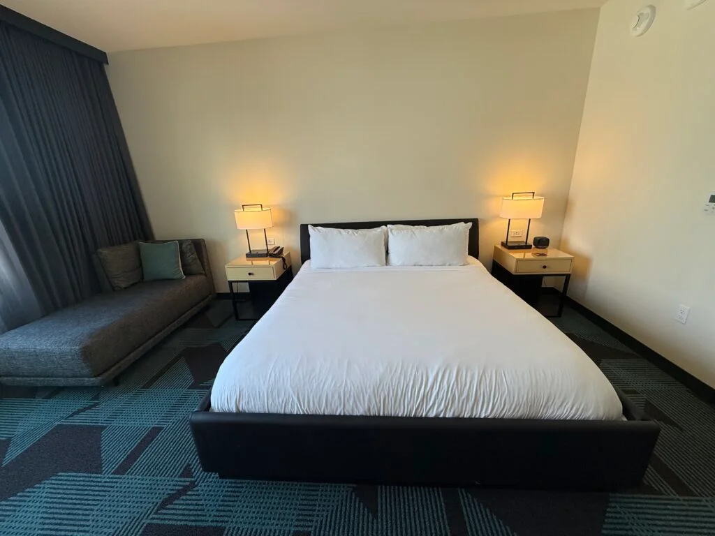 A king bed, sunk into a bedframe. 