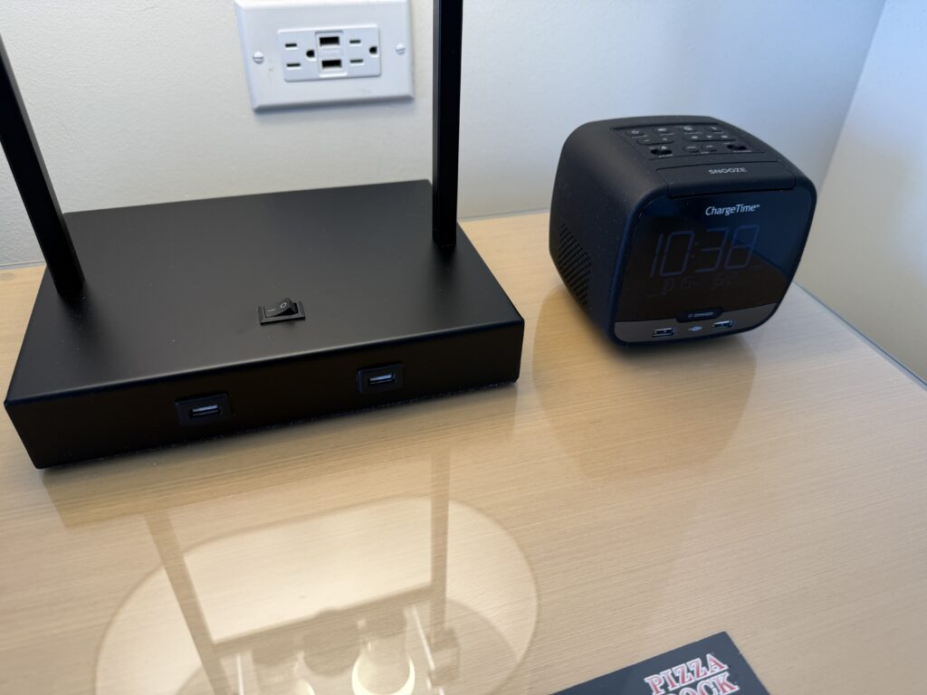 A close up of bedisde charging options that inlcuded outlets and USB-A ports.