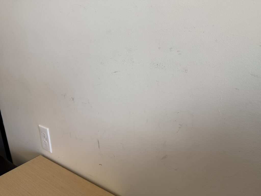 dark scuff marks above the bench on the wall.