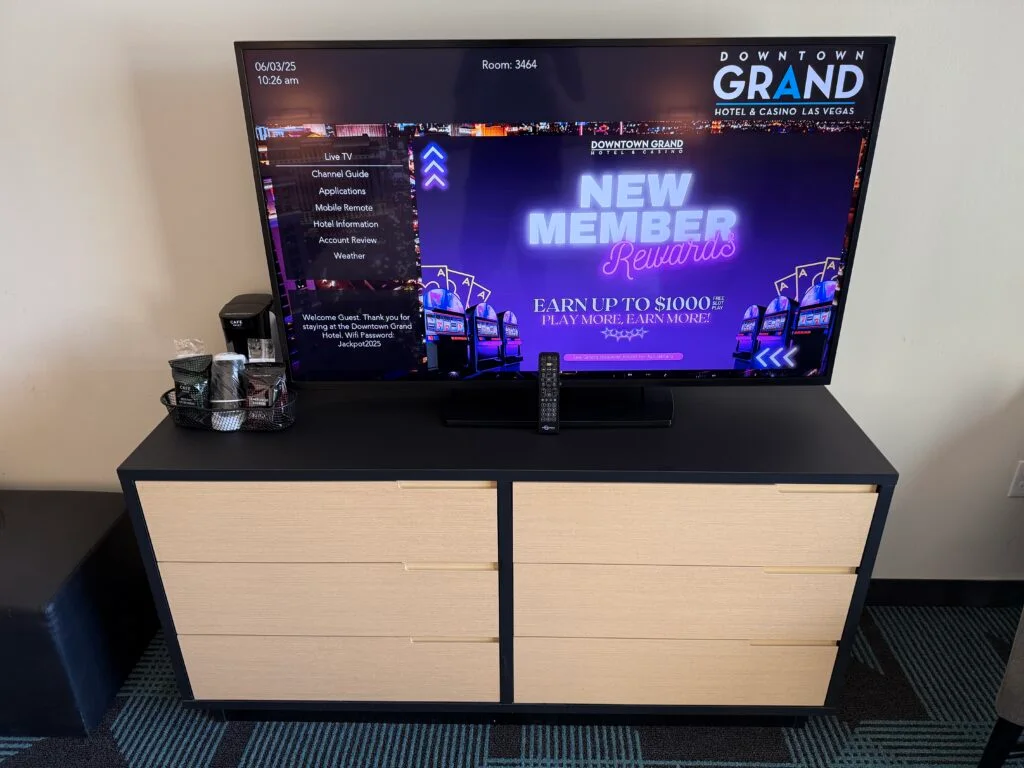 A modern TV atop a dresser. 