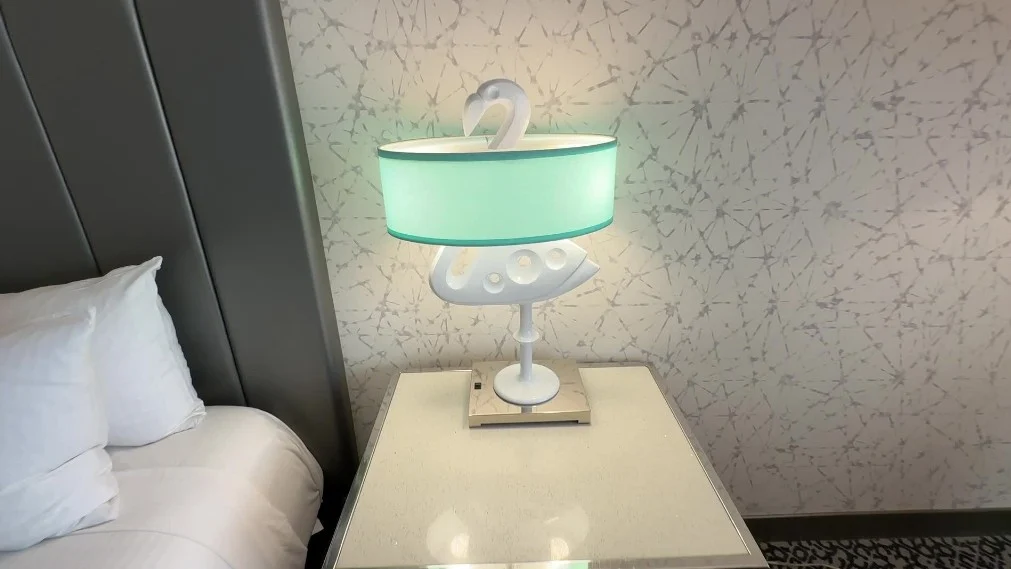 A lamp, with a stand in the shape of a flamingo. 