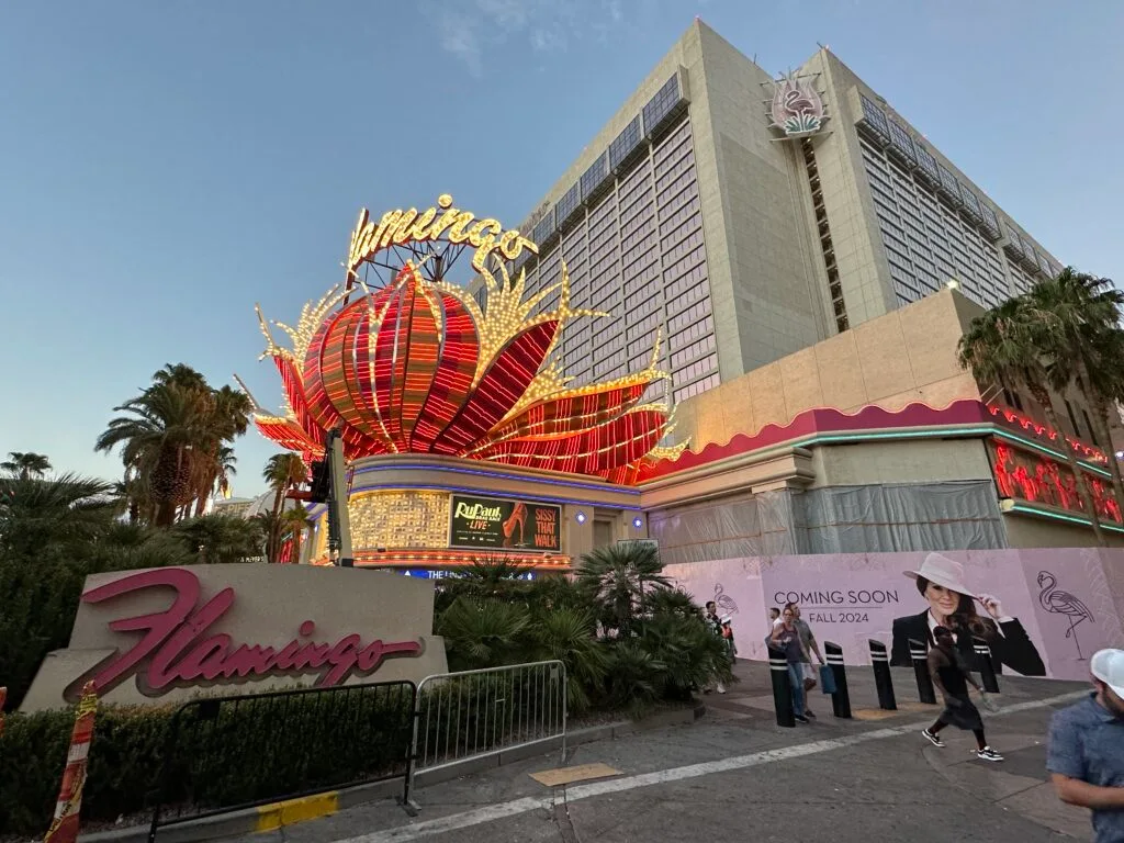 Exterior of Flamingo, with the neon red feather poof above the entryway the focal point.