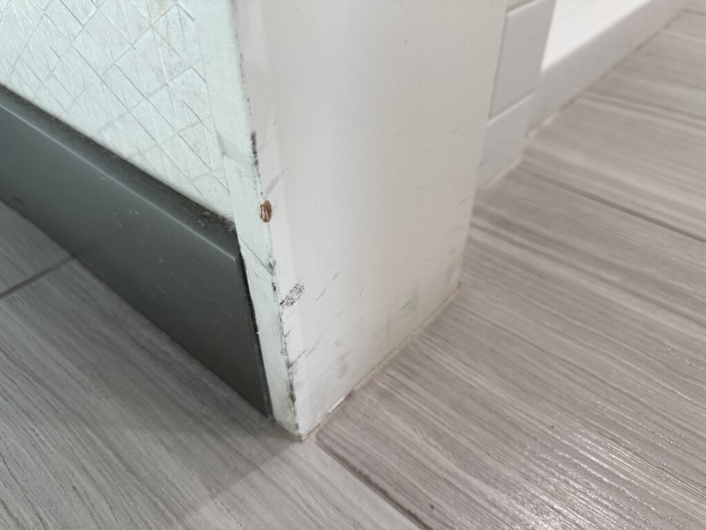 dark scuffs on the base of a doorframe.