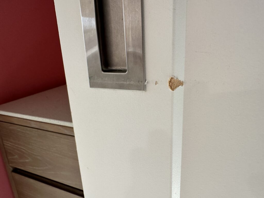a gouge in the bathroom door.