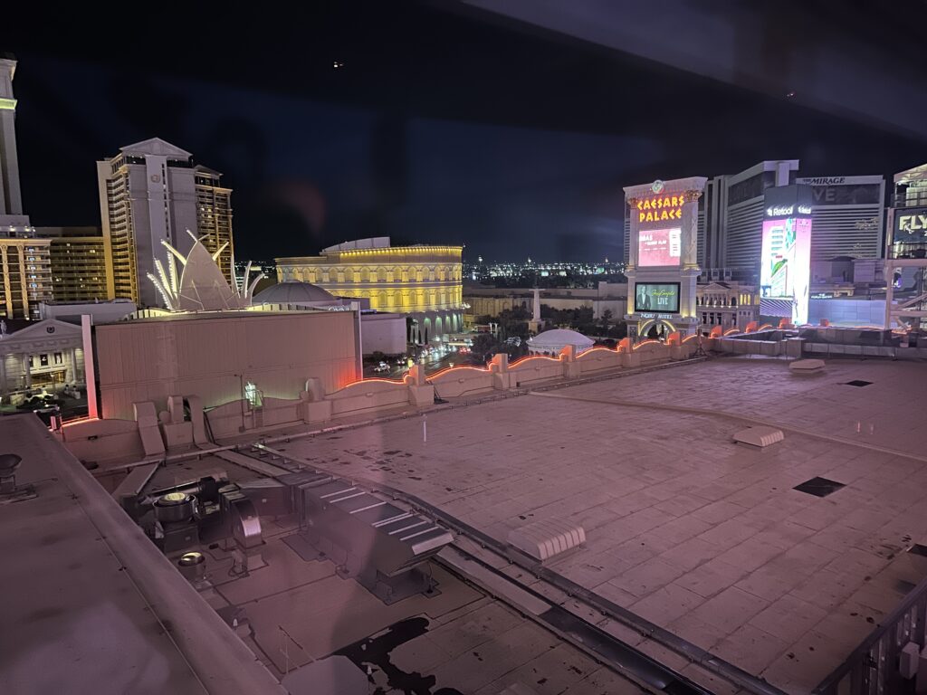 A view of the rooftop in the foreground, and Caesars Palace across the street in the background.