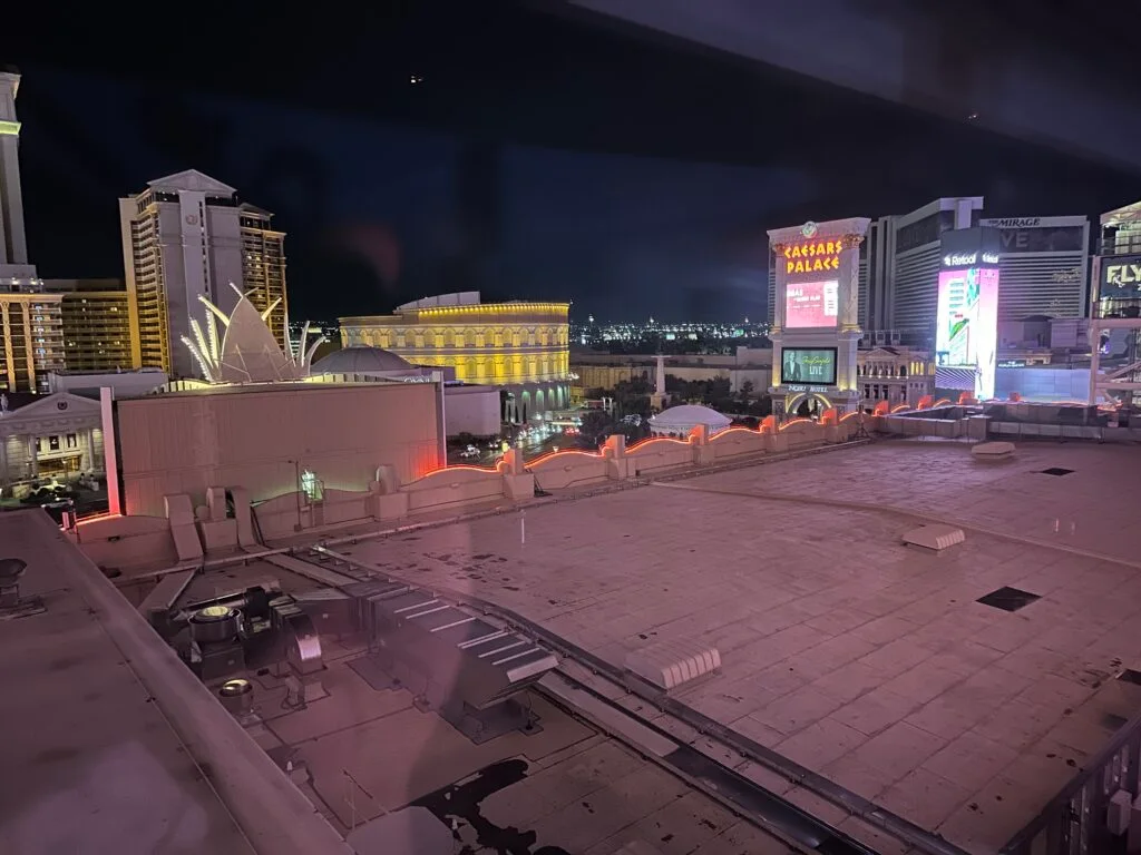 A view of the rooftop in the foreground, and Caesars Palace across the street in the background. 