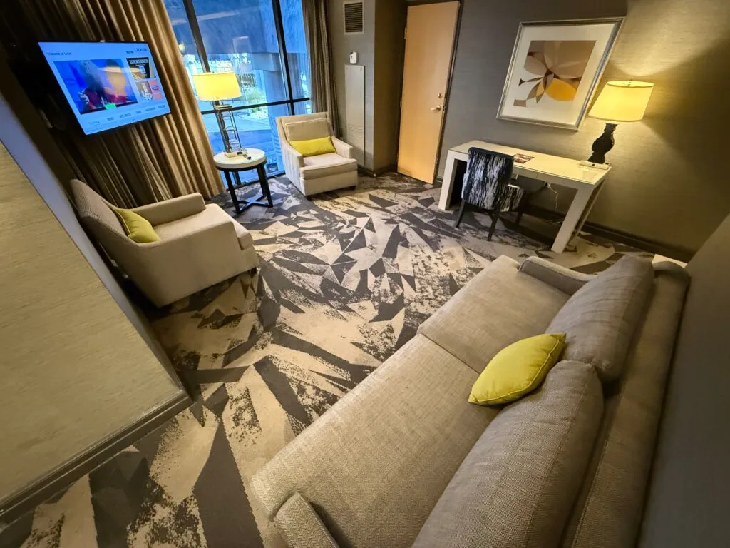 Another angle of the living area, showing the seating pointed at the tv, mounted in the corner of the room. 