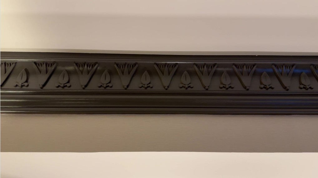 Crown Molding in the room with Egyptian etchings.