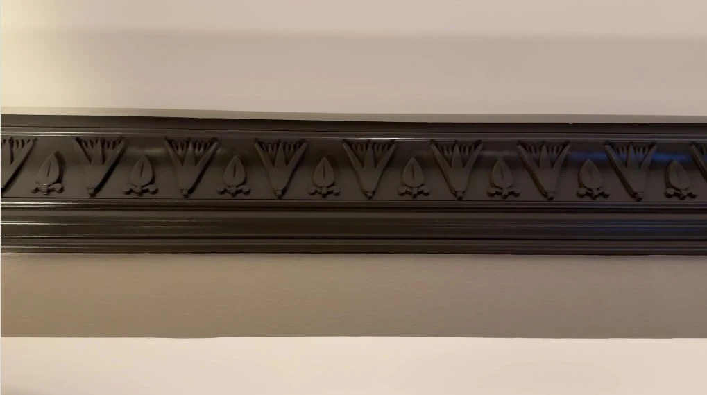 Crown Molding in the room with Egyptian etchings.