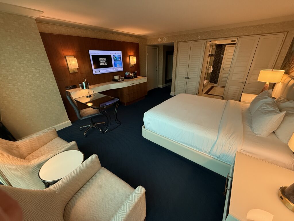 An angle of the room with the king bed pointed at the tv mounted across the room.