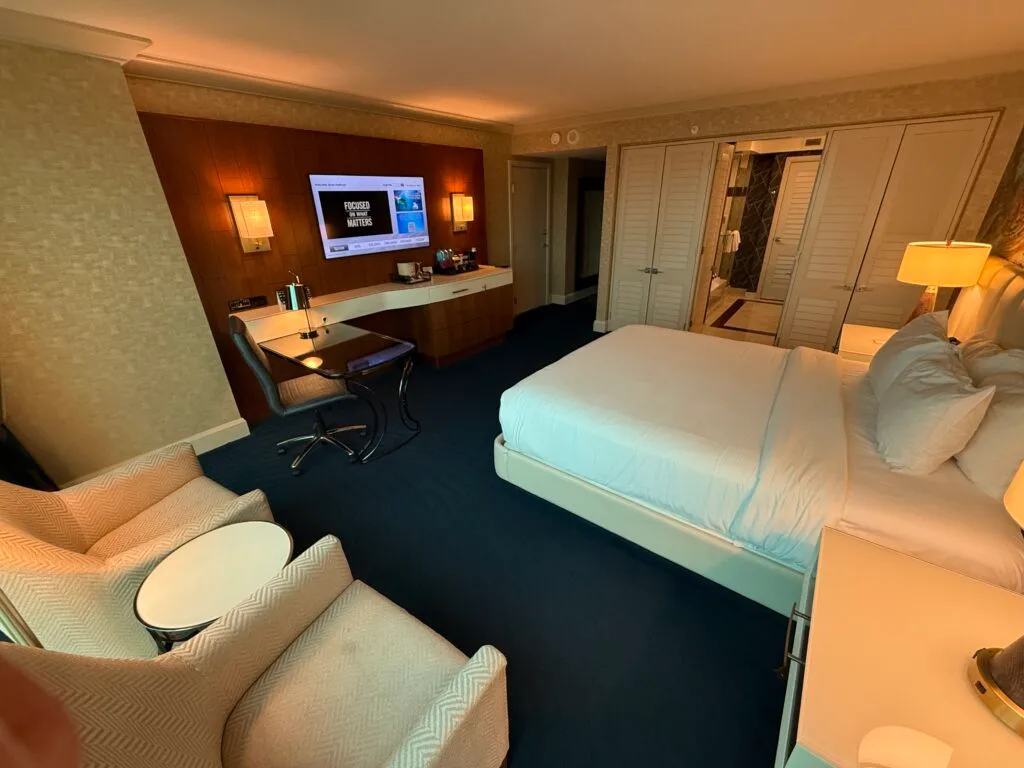 An angle of the room with the king bed pointed at the tv mounted across the room.