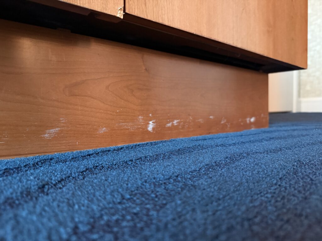 A scuffed up baseboard.