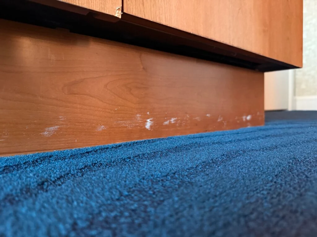 A scuffed up baseboard.