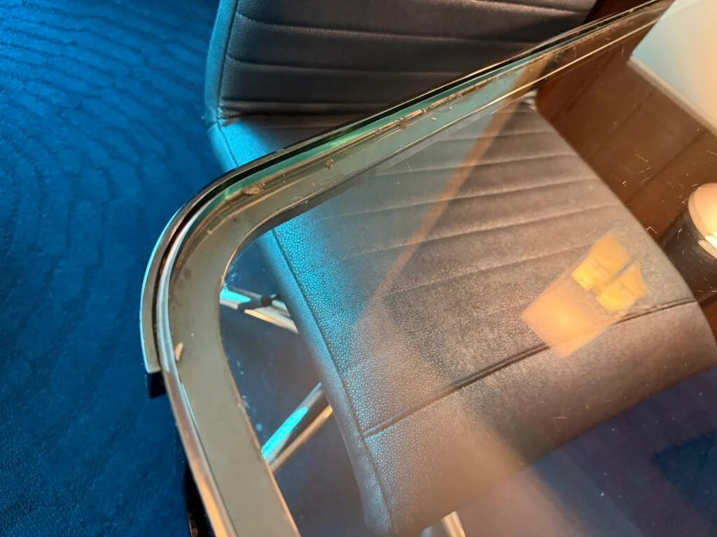 Crumbs and dust underneath the glass top of the workdesk.