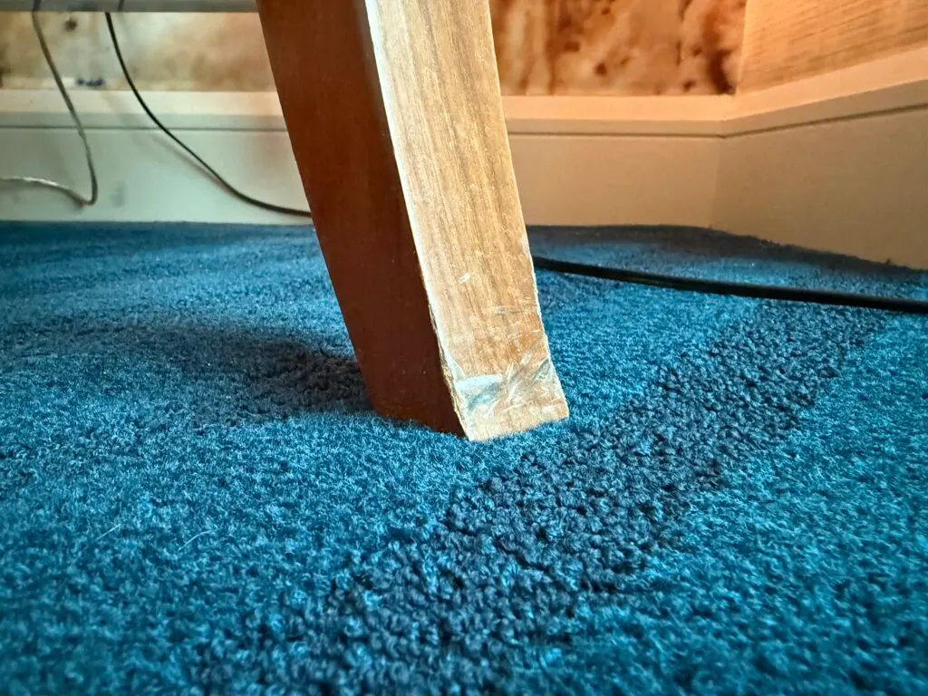 A chair leg with scrapes.