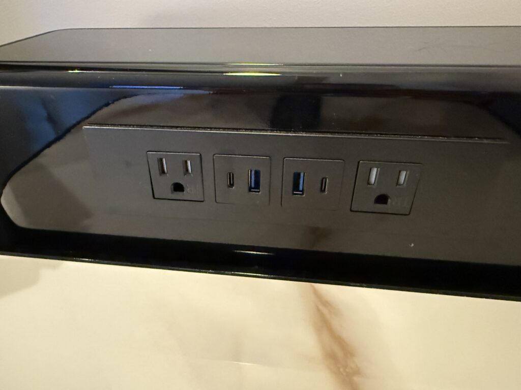 Bedside charge bank with outlets and USB ports.
