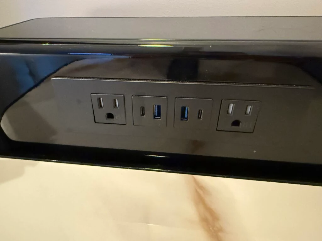 Bedside charge bank with outlets and USB ports. 