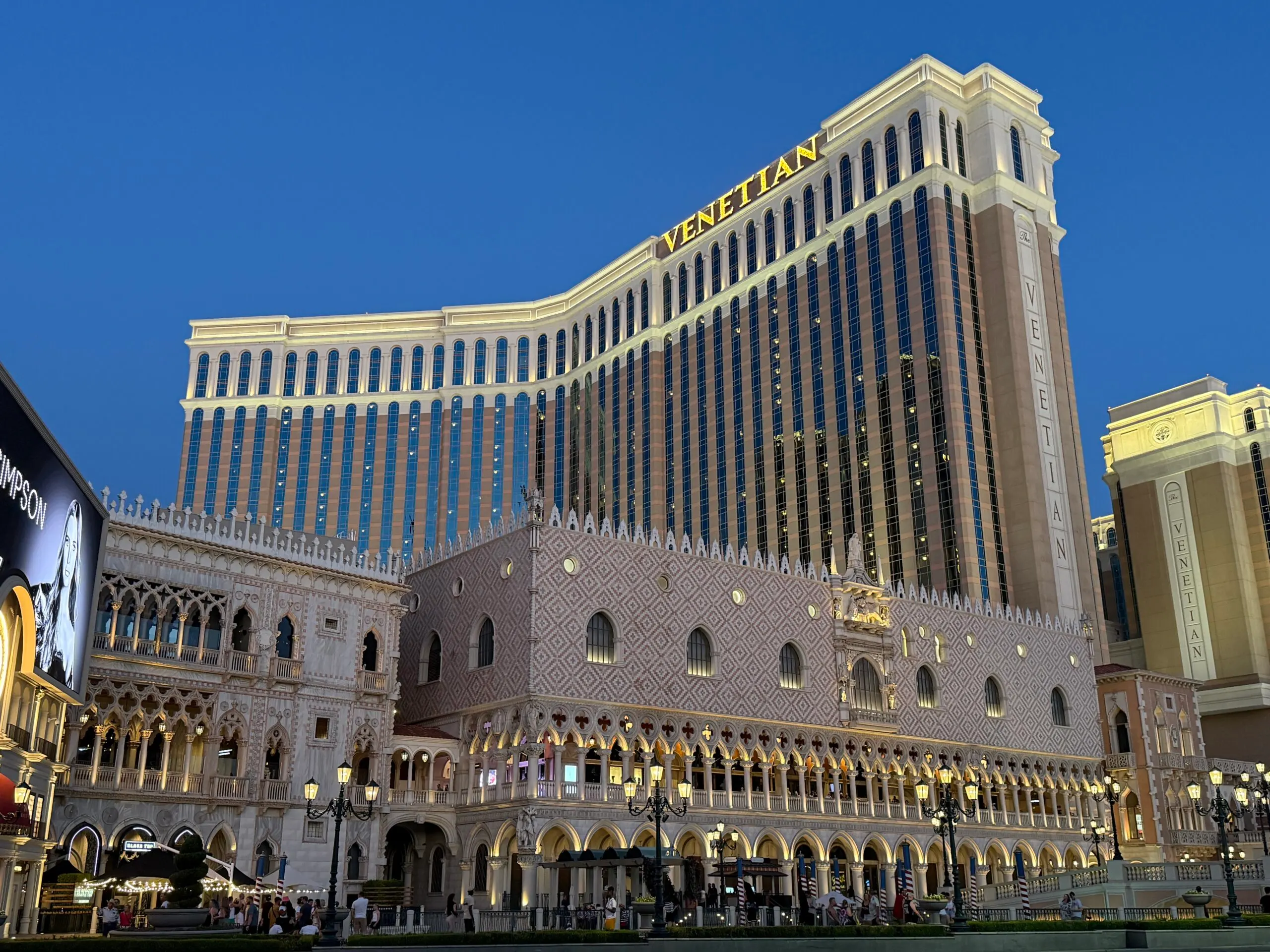 Exterior of The Venetian illuminated at night.