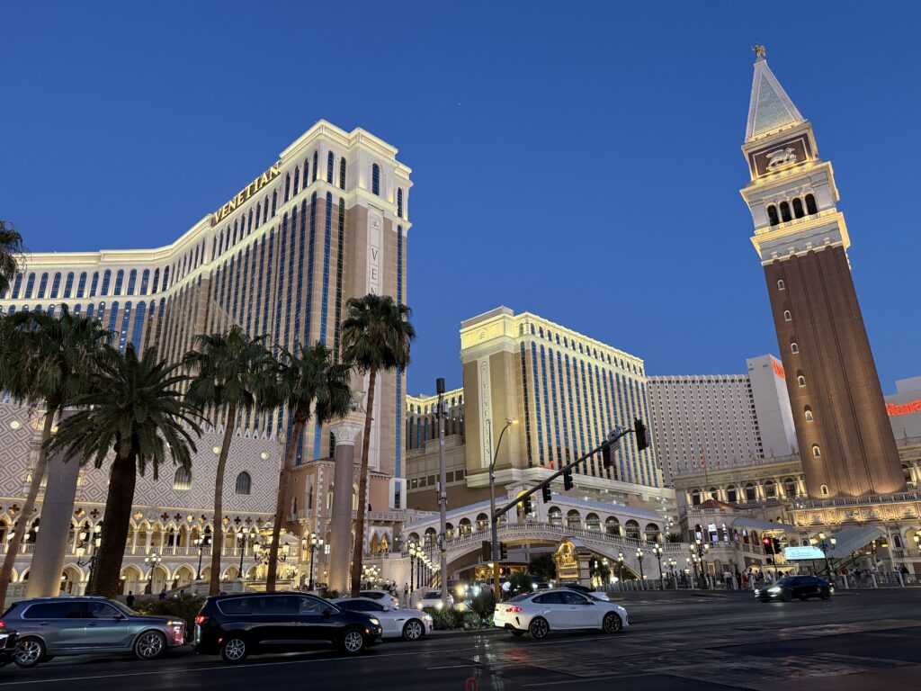 Exterior of the Venetian Las Vegas at night, with the iconic bell tower on the right.