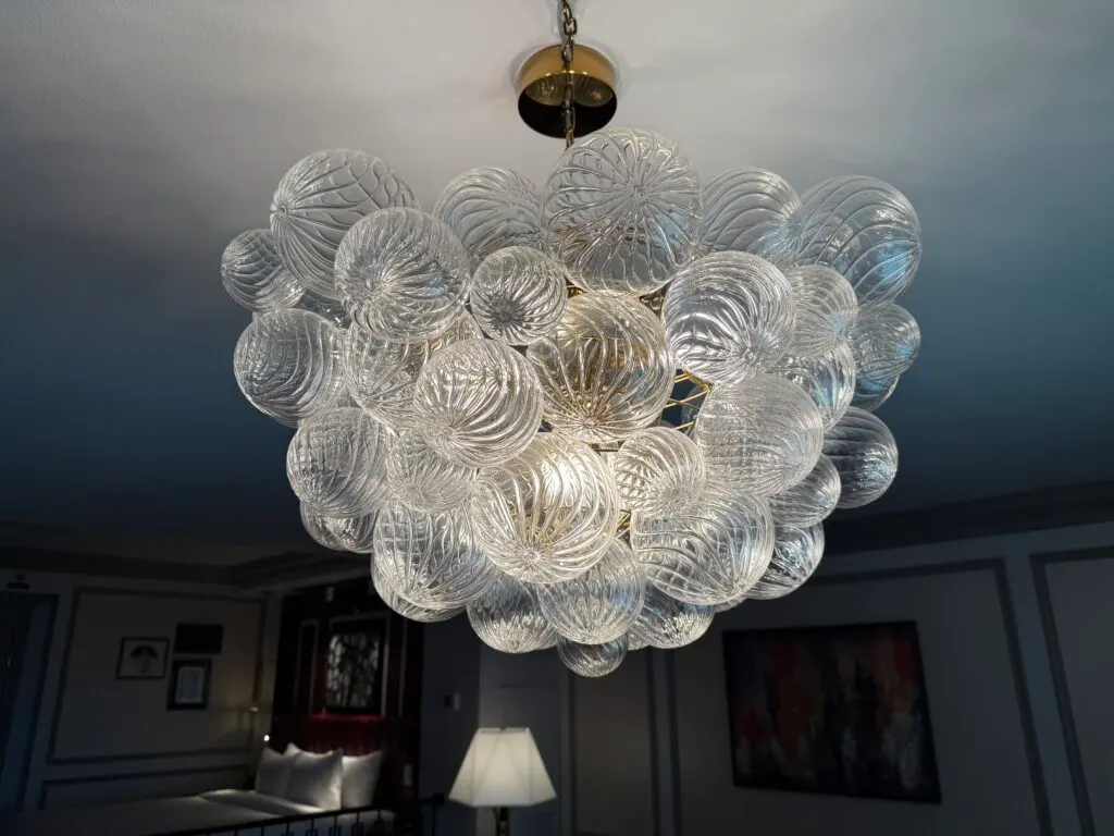 A glass light fixture hanging from the ceiling. 