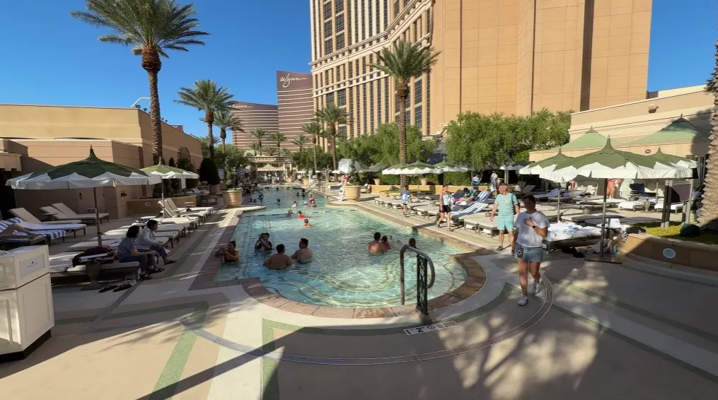 A pool with Palazzo, Wynn, and Encore in the background.