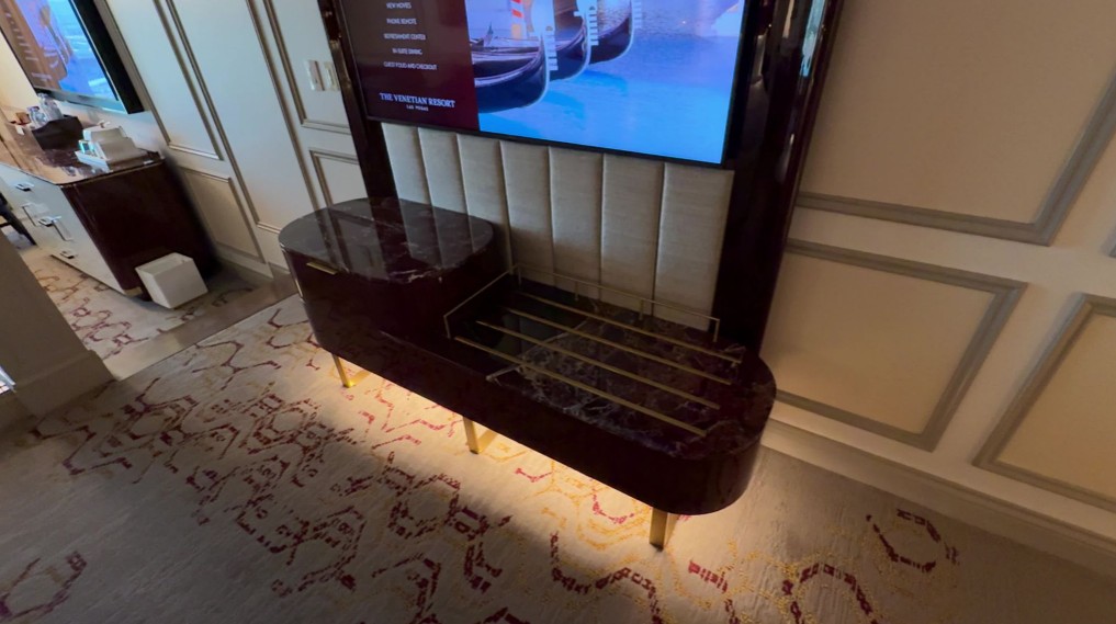 A motion activated light on underneath a bench in the bedroom.