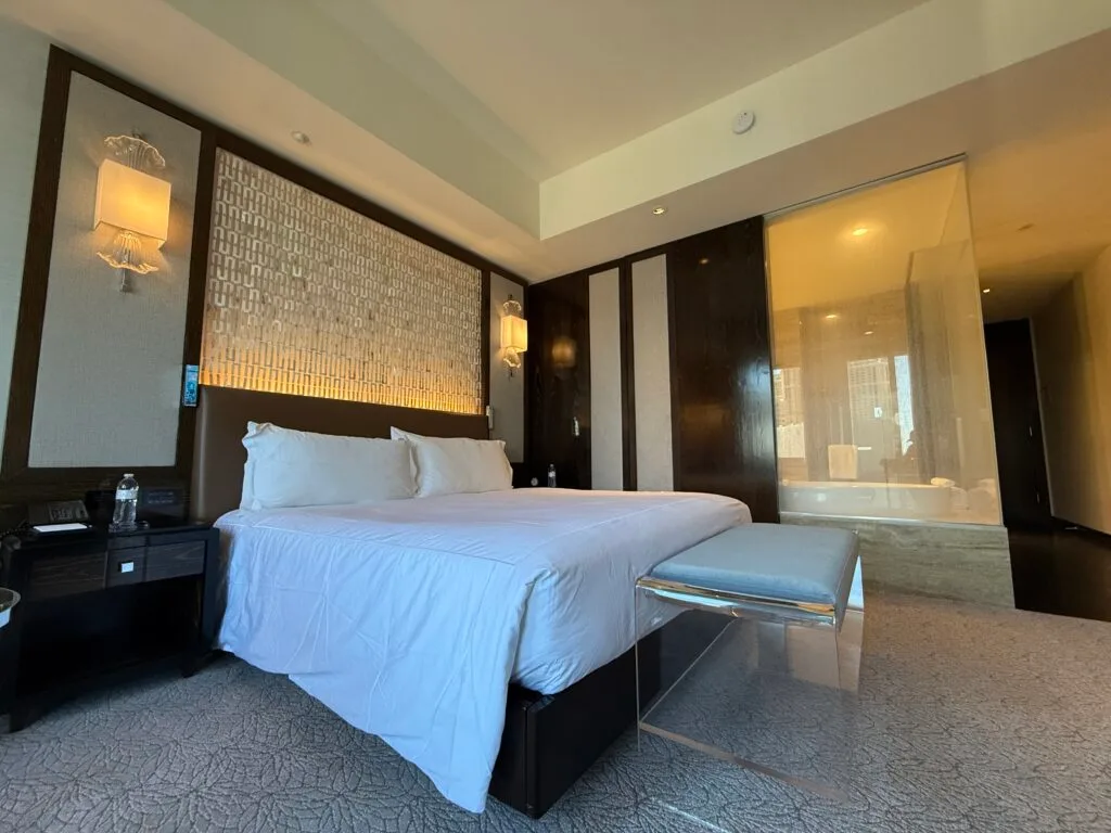 A closer shot of the bed,that shows a bench at the end. 